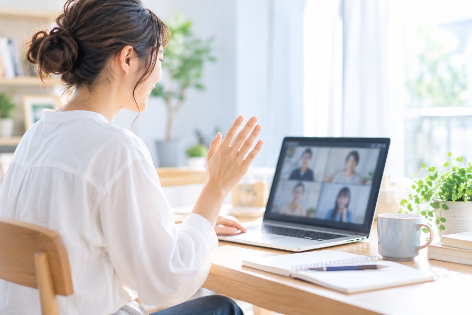 オンラインの勉強会で、画面に向かって手を挙げて質問しているフリーランス